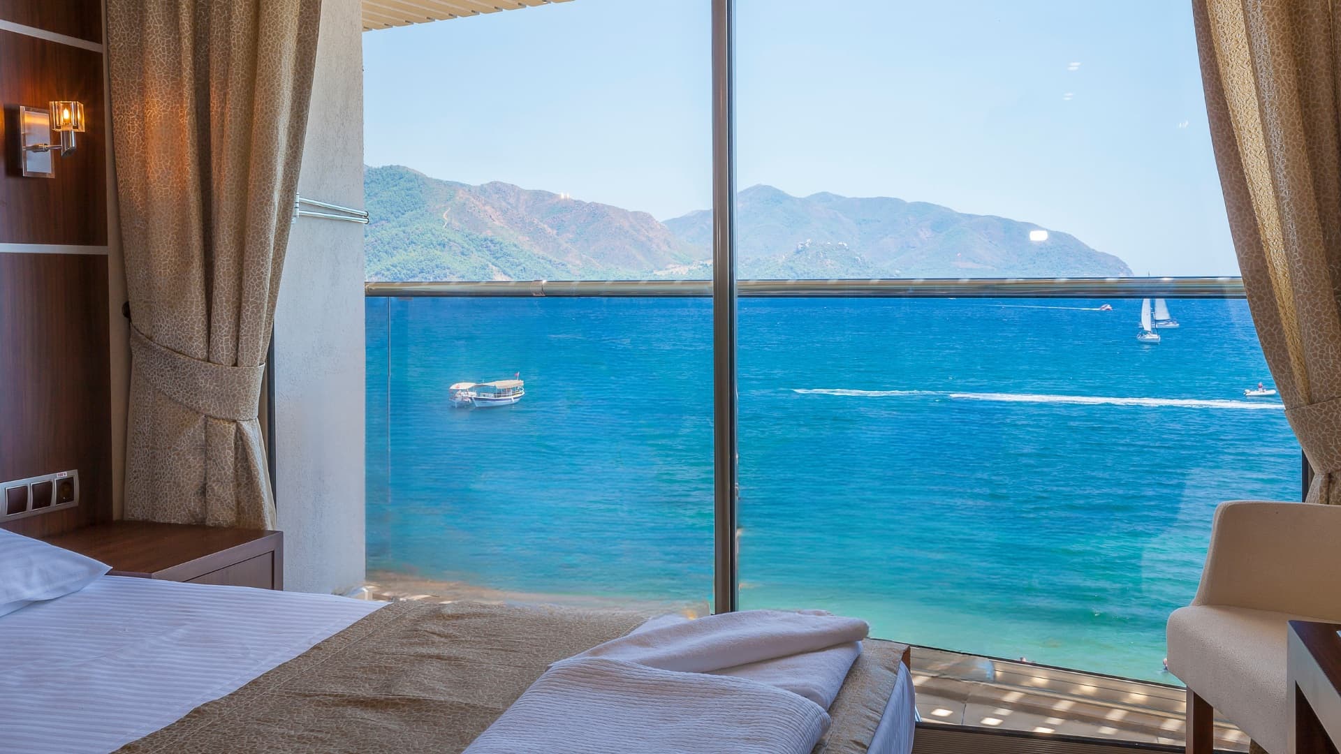 Hotel room with sea view and Smartell IPTV interface on TV