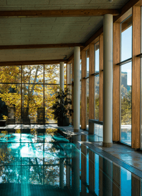 Modern indoor pool area with IPTV entertainment